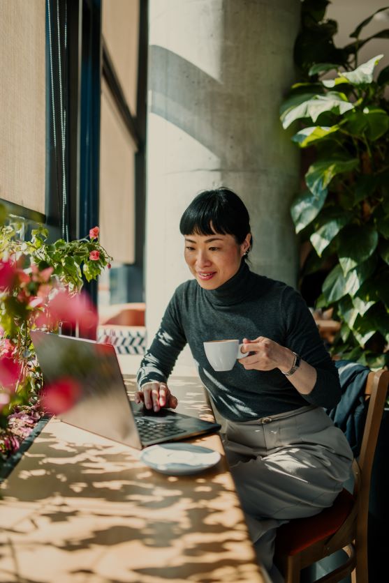 Women looking at a laptop having a coffee